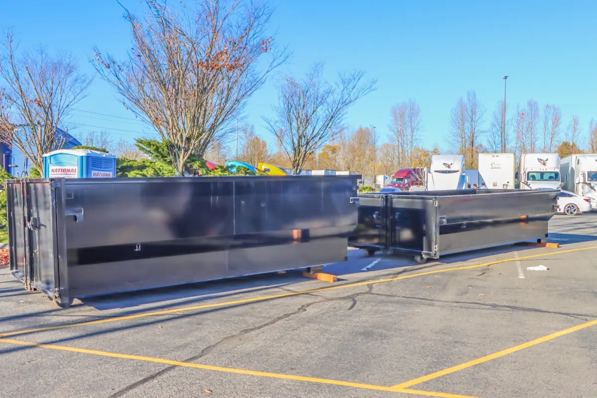 Professional dumpster rental service with roll-off container on residential driveway in Herculaneum